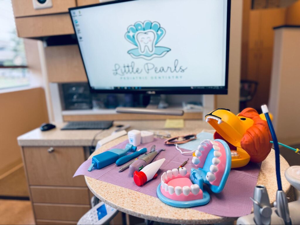 Colorful dental tools and educational models in an exam room at Little Pearls Pediatric Dentistry, highlighting a fun, child-friendly environment.