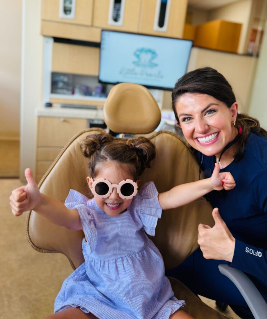 Smiling child and Dr. Mary Margaret Kratz showing excitement after a positive pediatric dental visit at Little Pearls Pediatric Dentistry St. Louis.